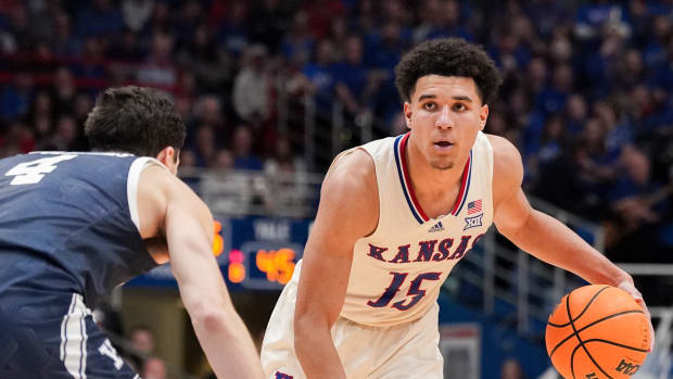 Dec 22, 2023; Lawrence, Kansas, USA; Kansas Jayhawks guard Kevin McCullar Jr. (15) dribbles the ball as Yale Bulldogs guard John Poulakidas (4) defends during the second half at Allen Fieldhouse. Mandatory Credit: Denny Medley-USA TODAY Sports  
